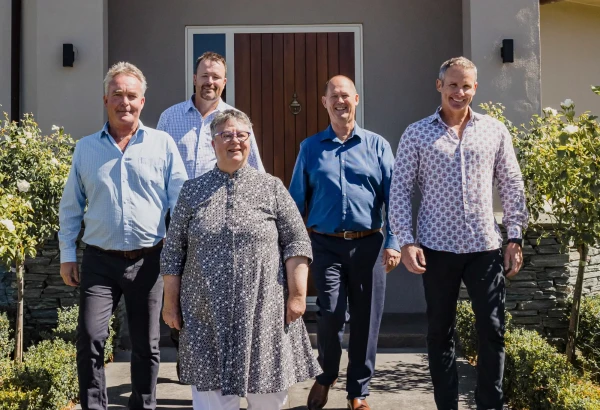 Pukeko rental managers in front of one of their rental properties