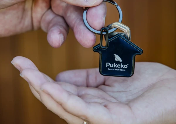 handing over keys to new pukeko rental home